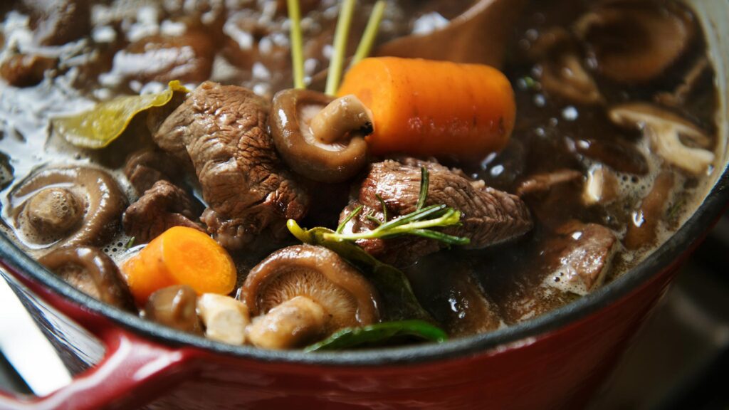 A red pot filled with Civet de Sanglier, a traditional stew