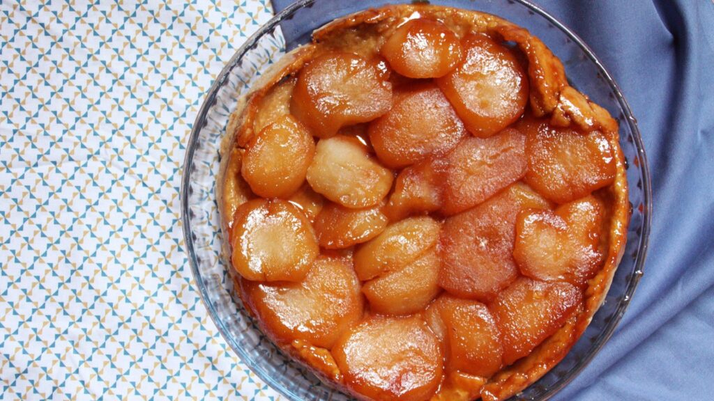 A french apple pie or tarte tatin in a glass dish