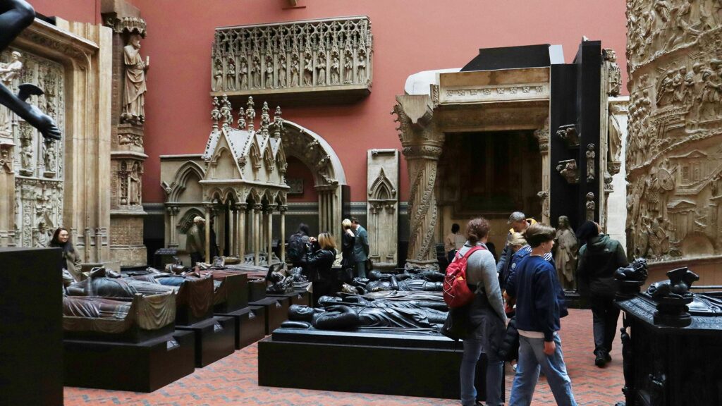 People walking through The Cast Courts at the Victoria and Albert Museum in London