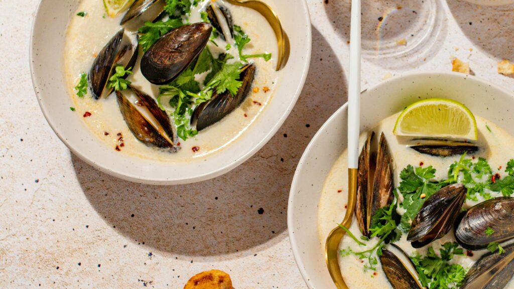 Two white bowls with moules a la creme – mussels in cream