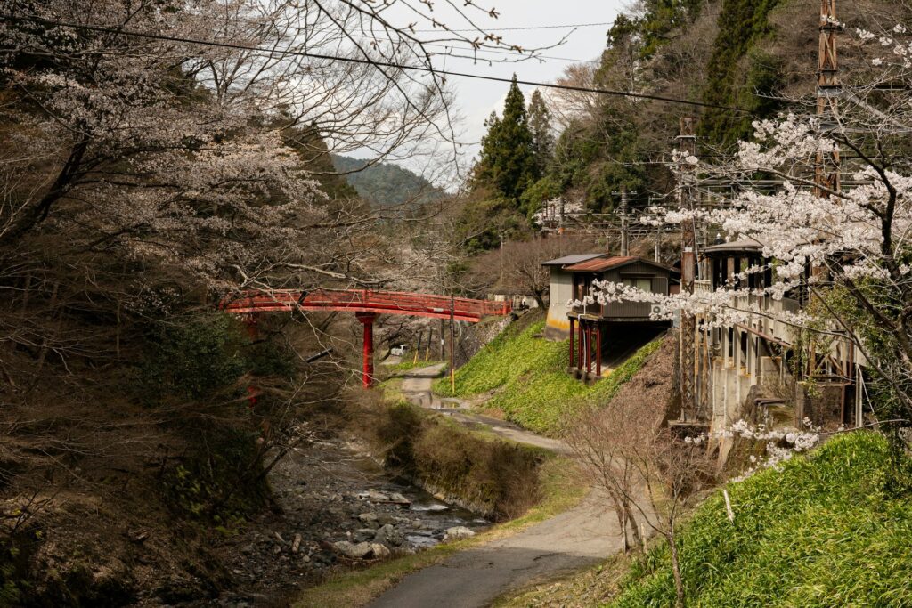 Red bridge over a stream in a rural village Japan