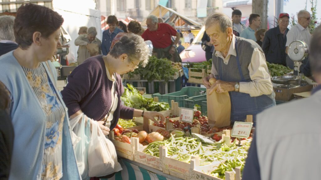 people shopping at a market stall 