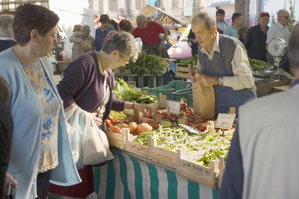 People shopping groceries at an outdoor market