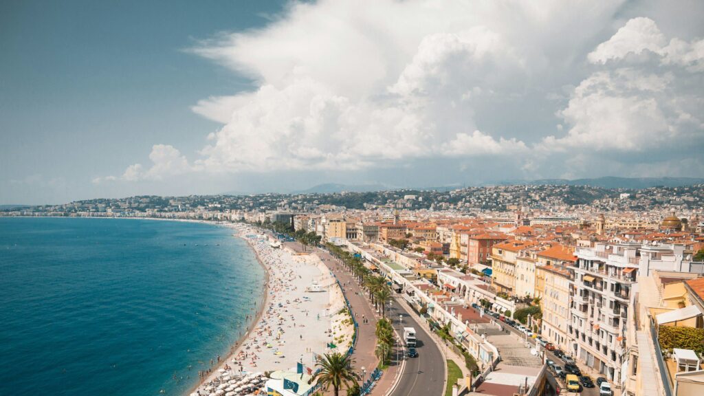 Aerial view of Nice, France with rain clouds rolling across the hills in the background