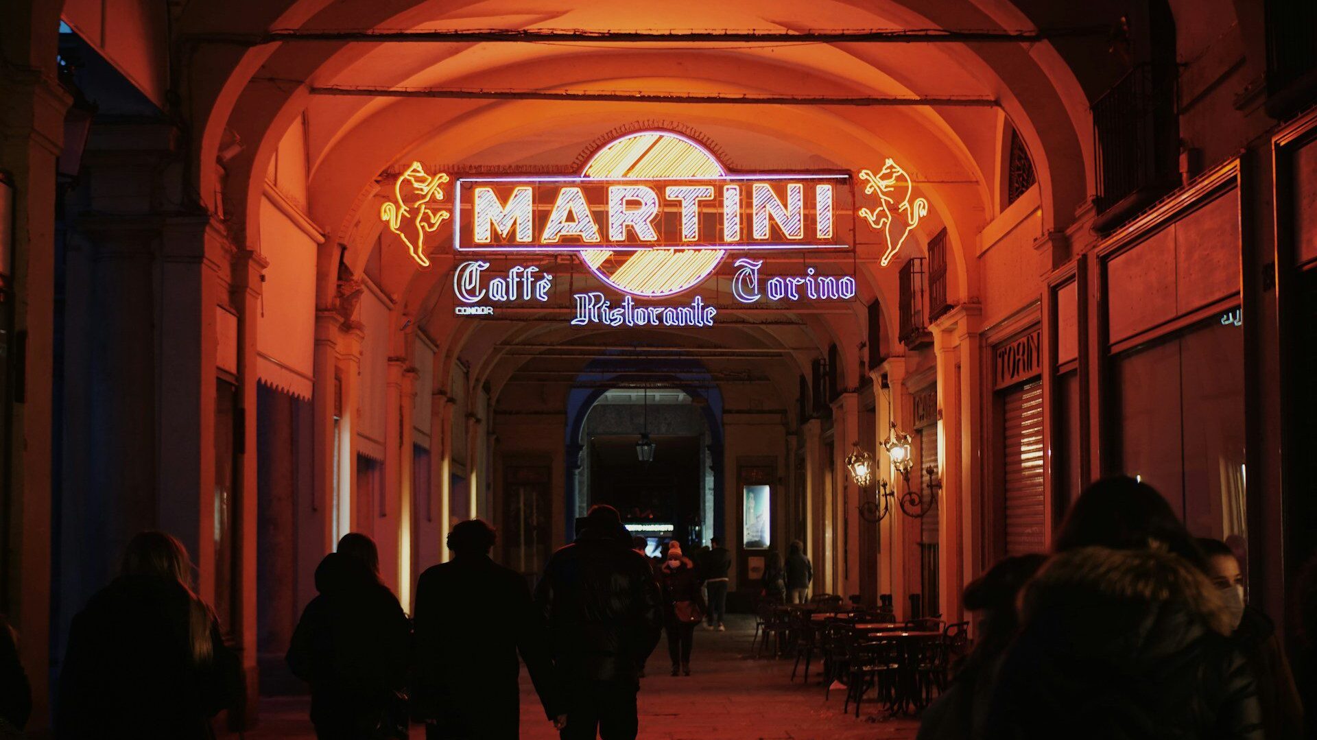 Neon Martini sign in a porticoed street