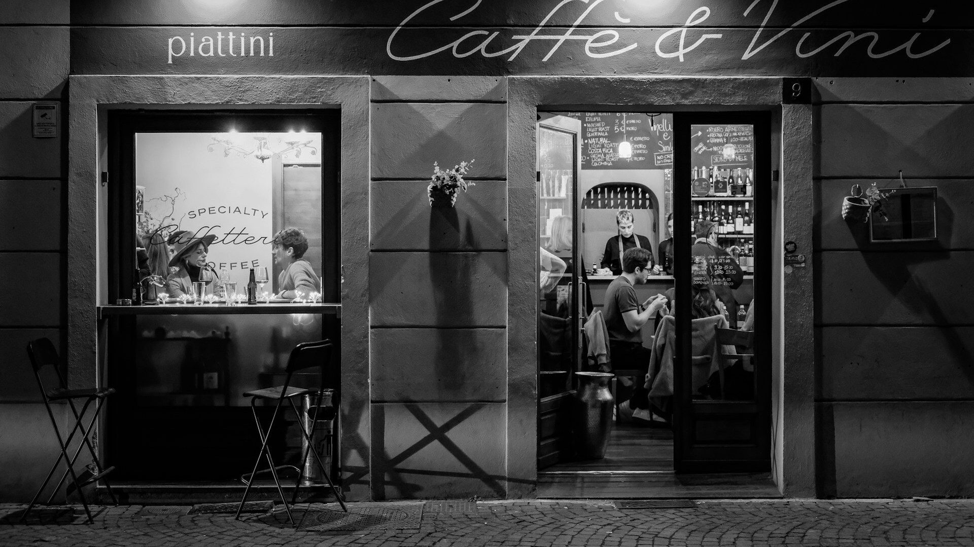 Black and white photo of a restaurant with diners inside
