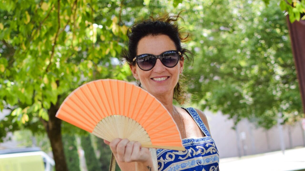 Headshot of Krista Taylor with orange fan