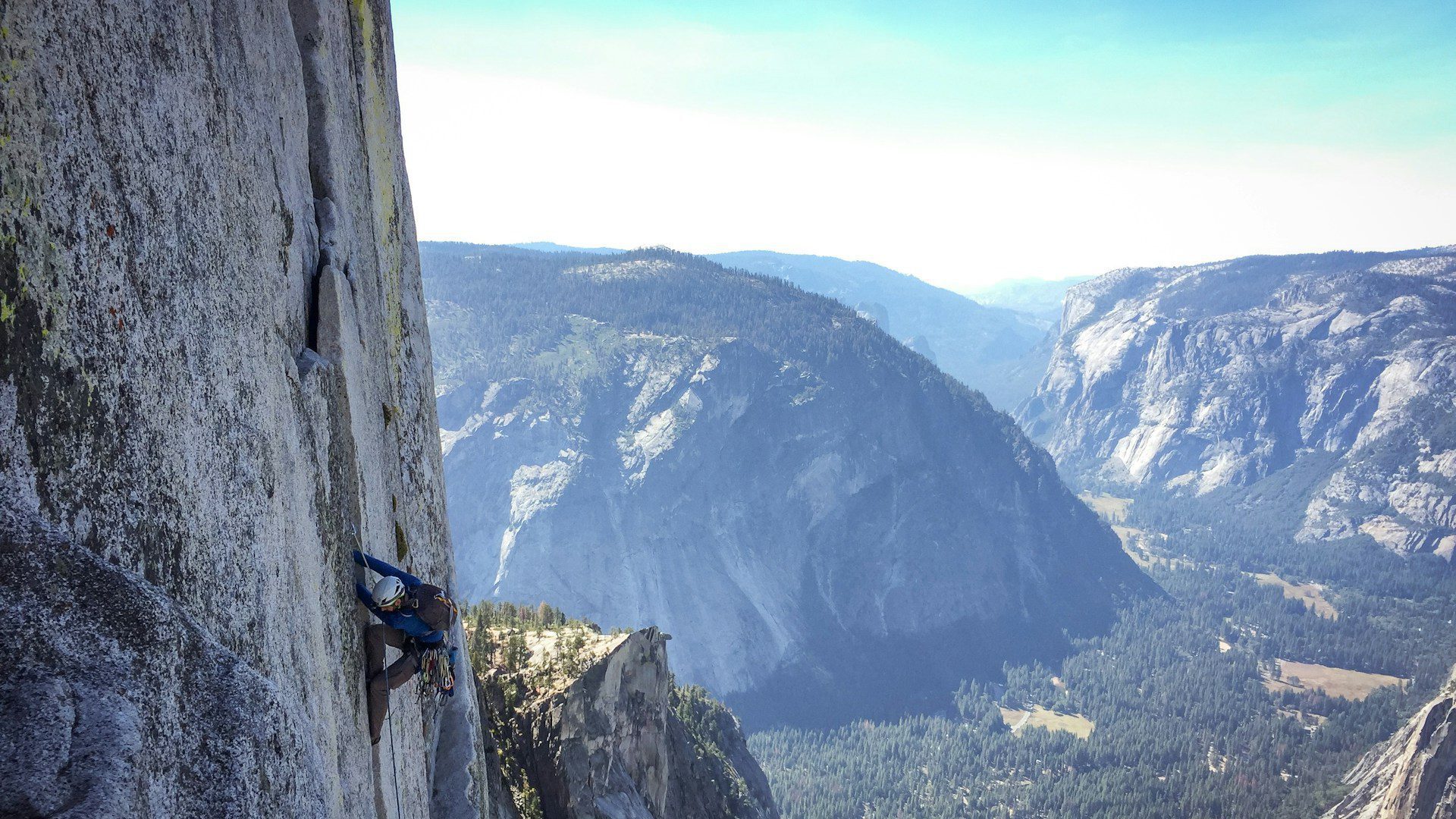 A rock climber on a sheer cliff