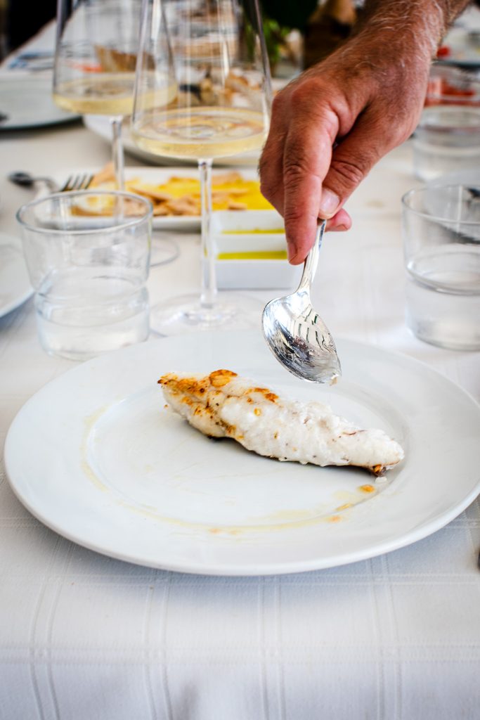 People eating at Getaria restaurant, closeup of hand