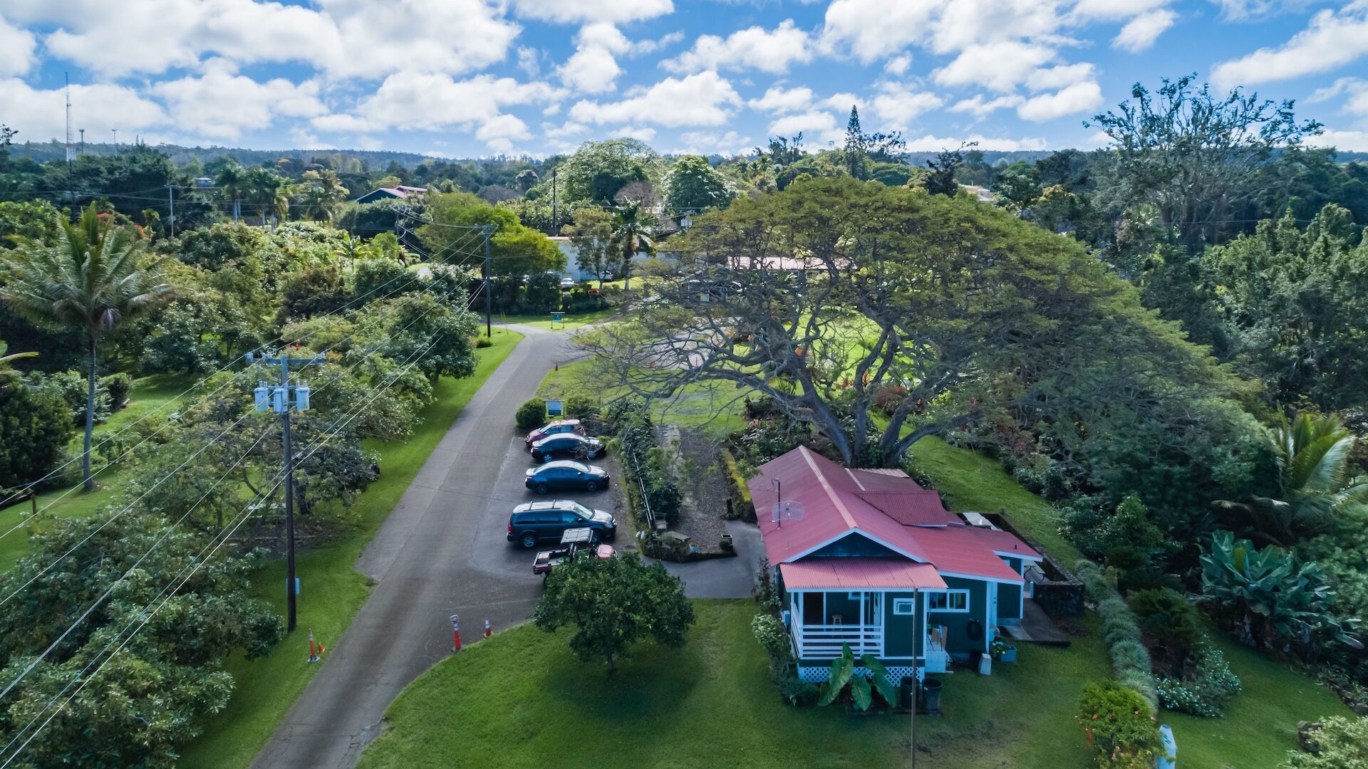 Aerial view of a house on lush farmland