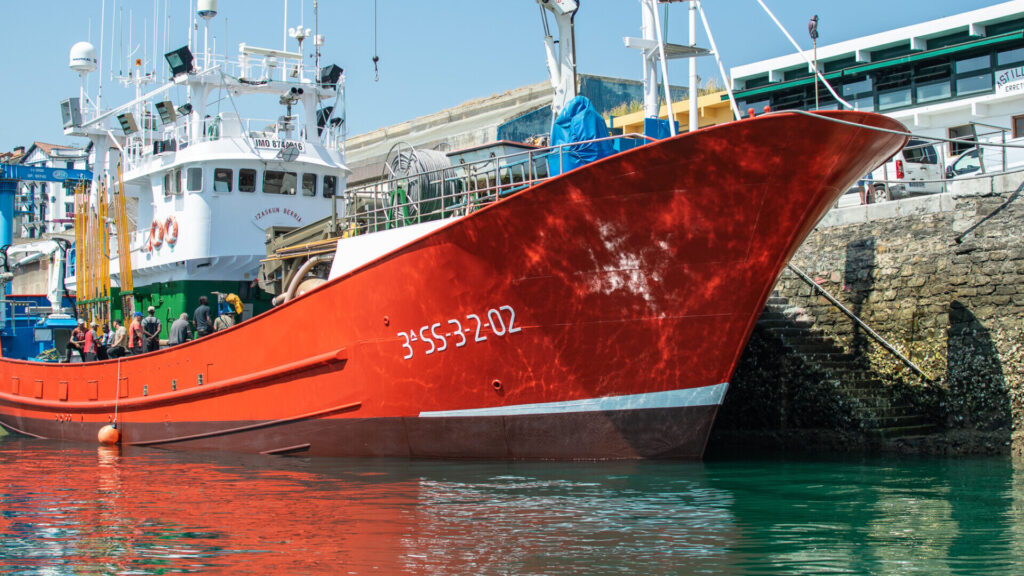Large red fishing trawler in a harbour