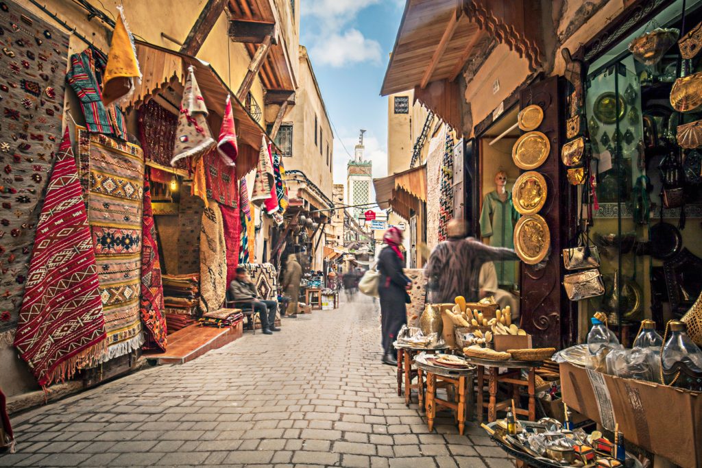 A narrow street in a vibrant city during a festive break.