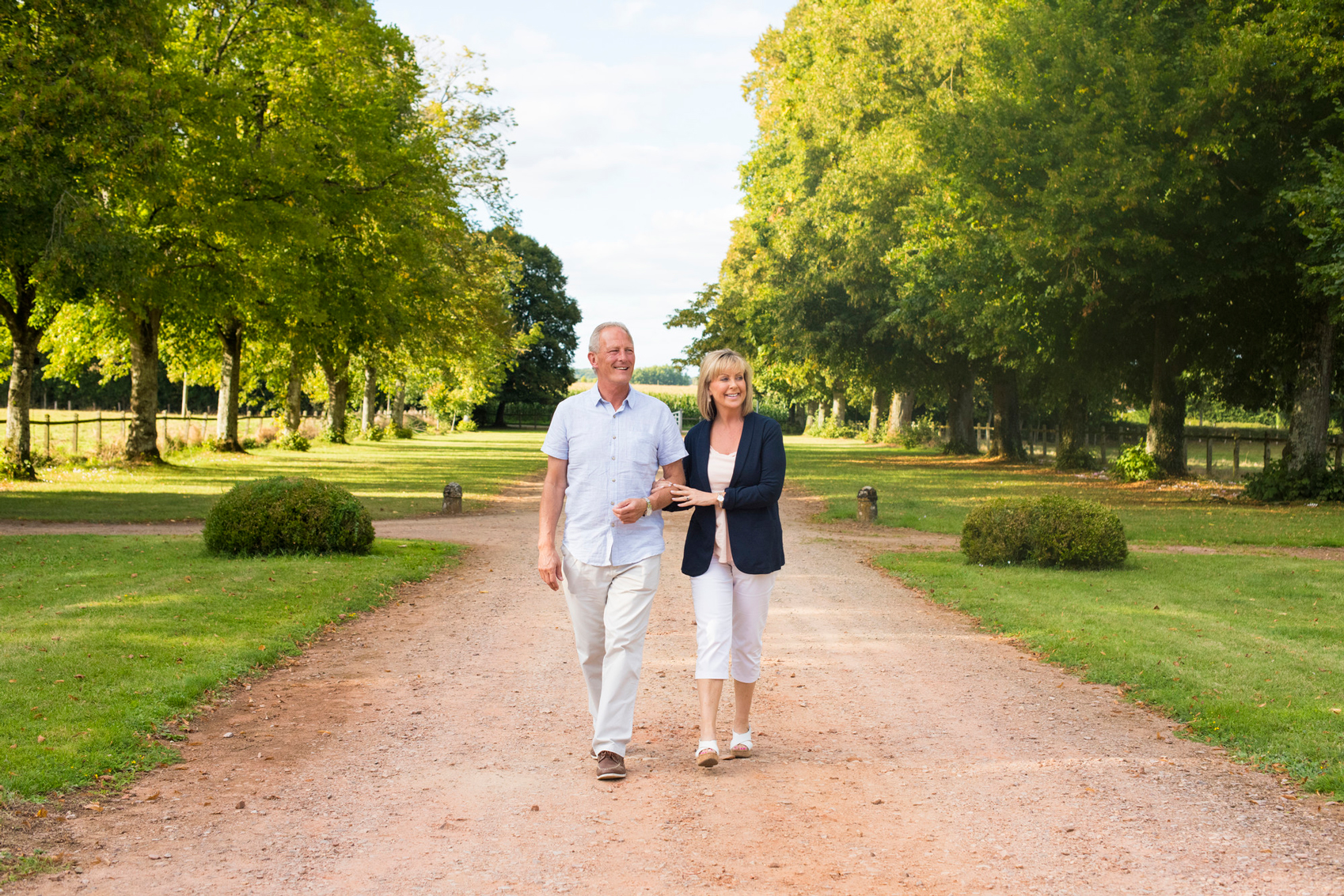 A couple walking through the gardens of Hôtel de Soubise in Paris a real Hidden Gem in Europe