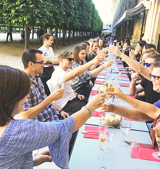 A group of people sharing travel moments, toasting.