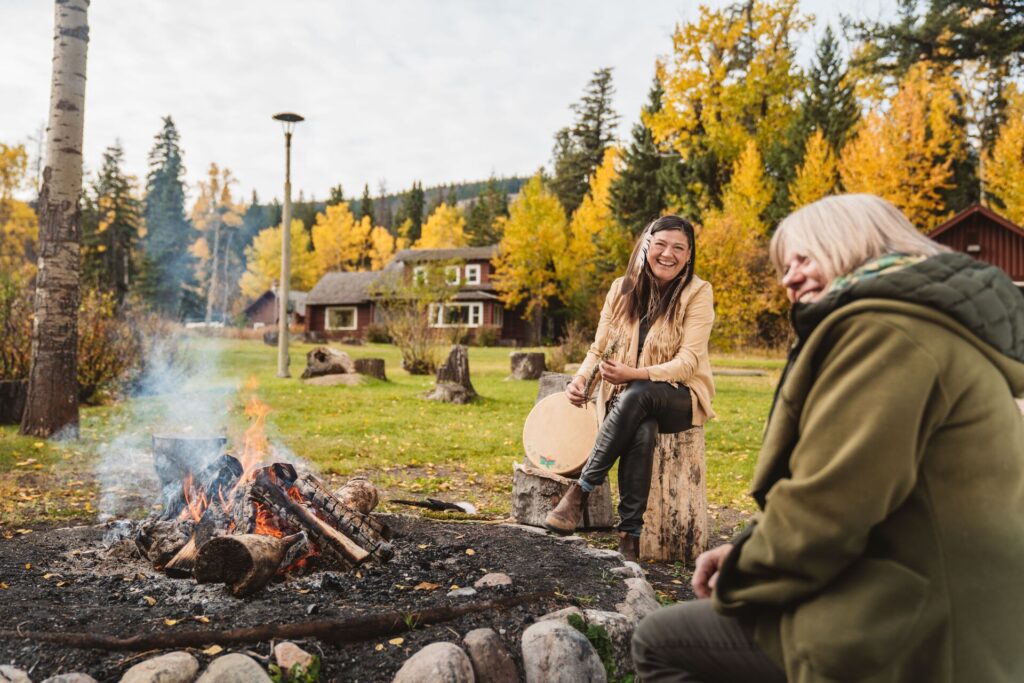 Two people round a campfire on a Be My Guest experience