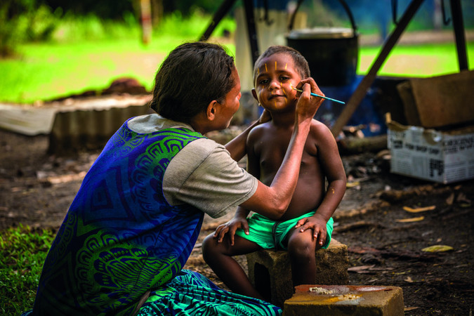 aboriginal mother painting face aboriginal child