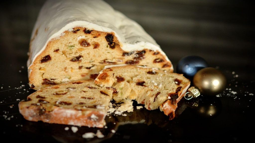 A slice of a Christmas cake with delicious icing and festive decorations, popular during the holiday season.