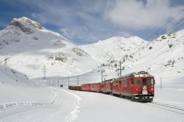 train travelling through snow switzerland