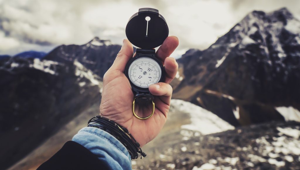 Hand holding compass