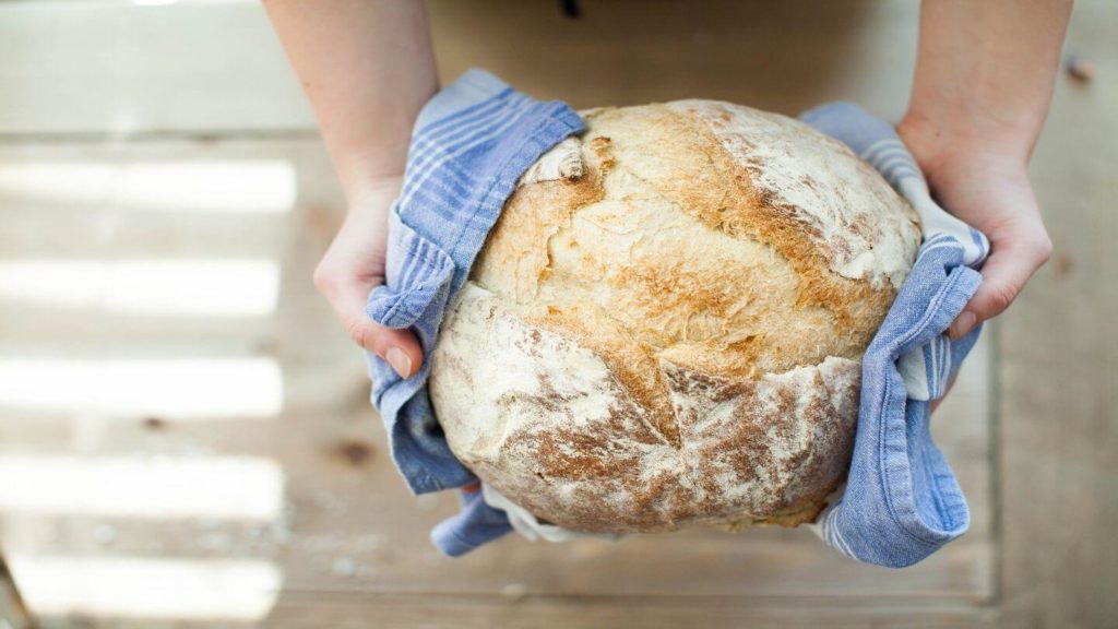 hands holding freshly baked bread