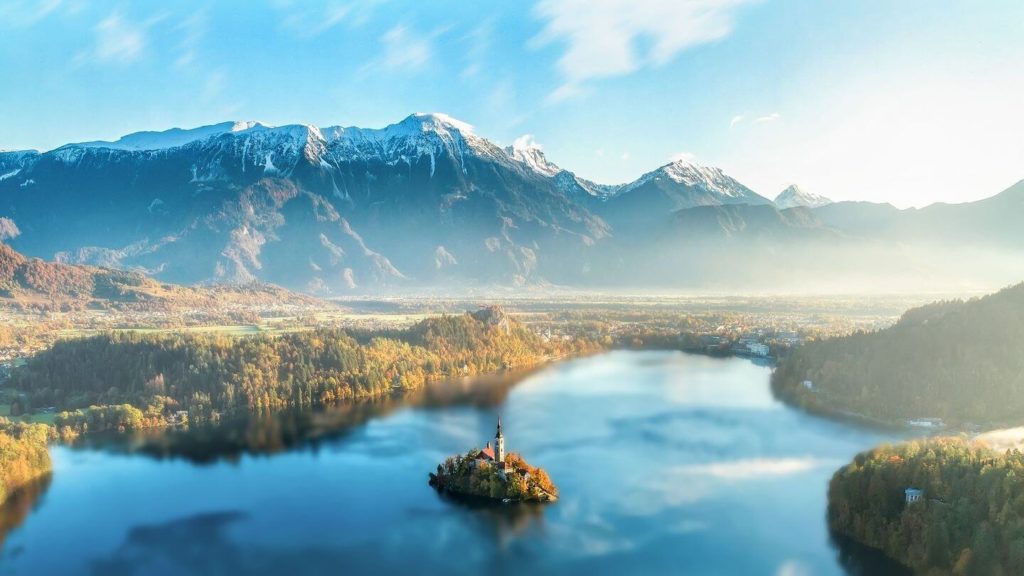 blue lake snowy mountains island church Lake Bled Slovenia