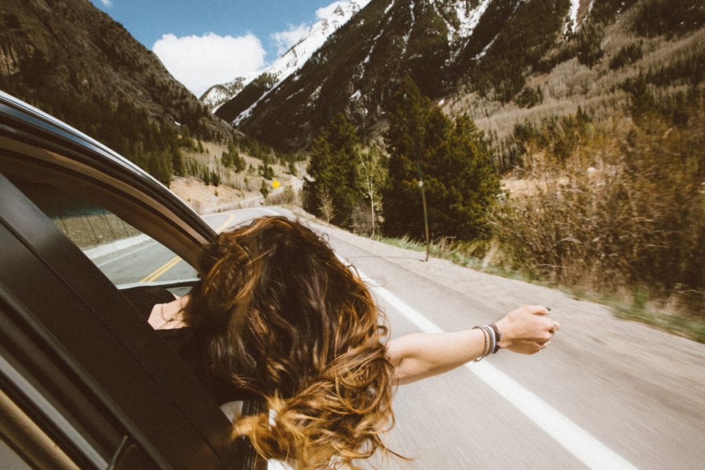 A woman enjoying the view on a countryside road trip