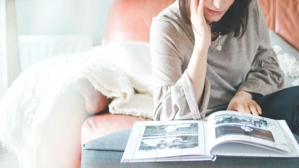 woman looking at photo album souvenir collections