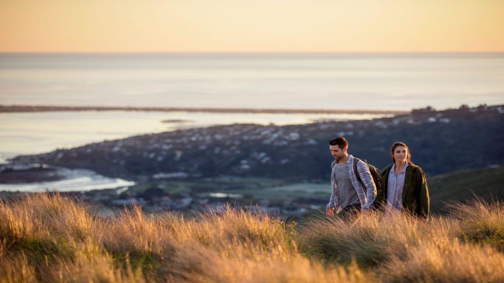 couple walking through Port Hills Christchurch New Zealand