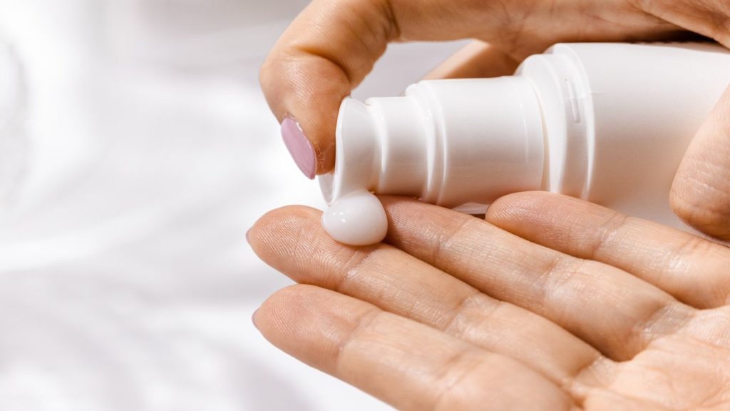 person applying hand cream travel hygiene kit