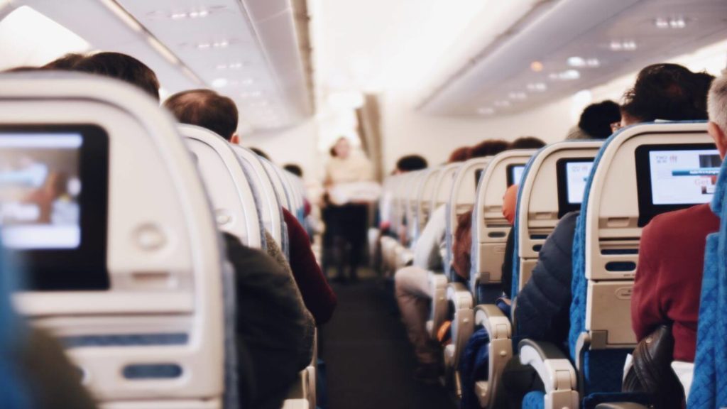 passengers sitting in airplane seats COVID-19 travel questions