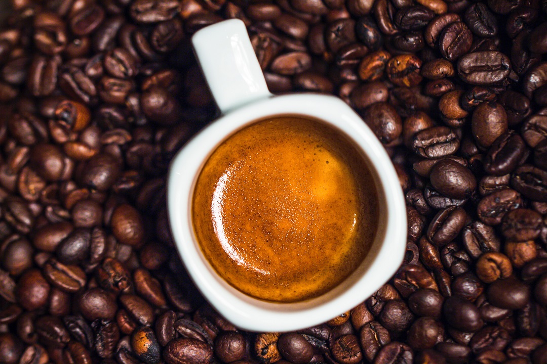 coffee surrounded by beans