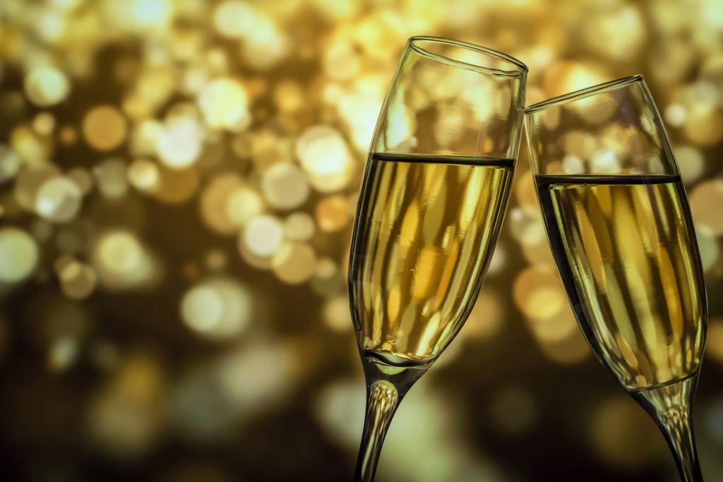 Two champagne flutes toasting