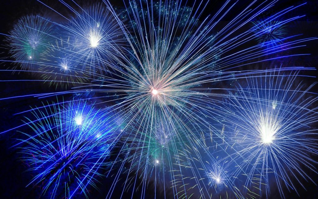 Blue firework display lighting up the night sky