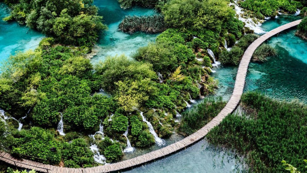 boardwalk through blue lakes and green forest of Plitvice Lakes National Park Croatia