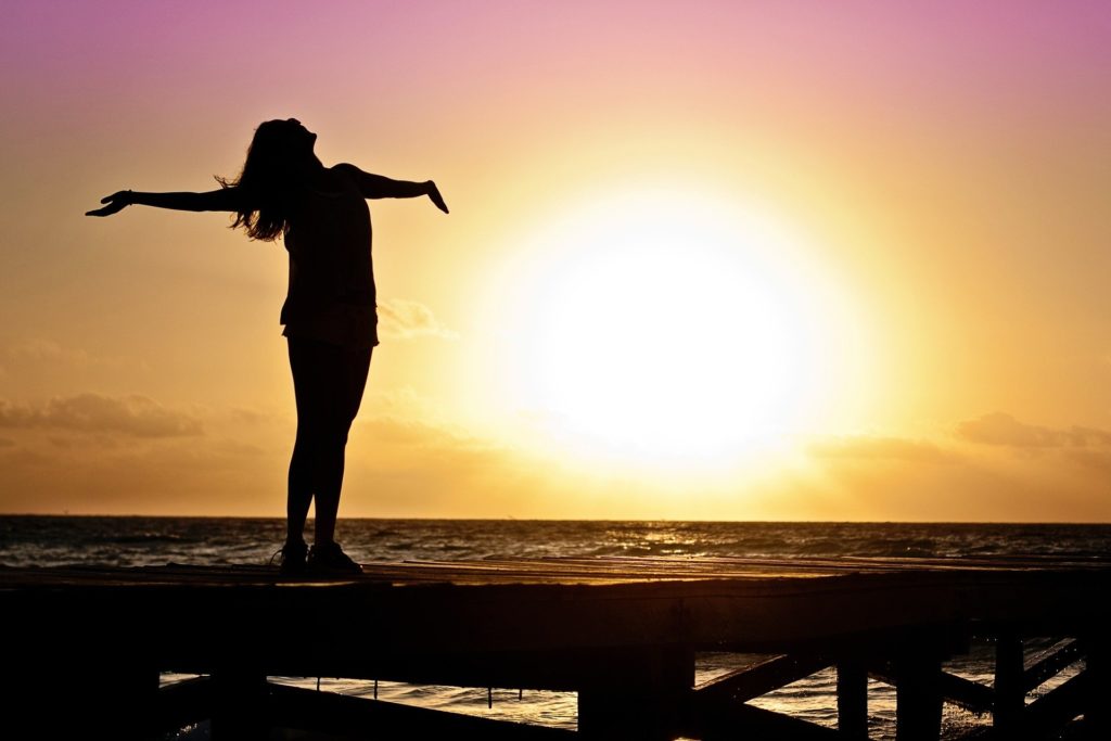 Female traveller embracing the sunshine and warm weather