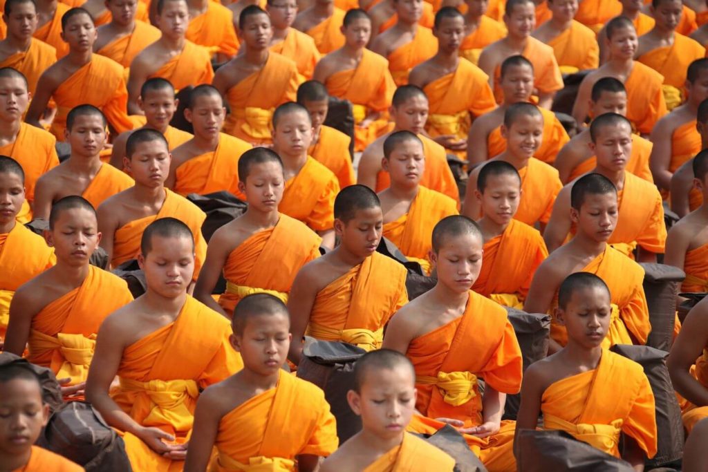 Buddhist monks in orange robes meditating Asian traditions