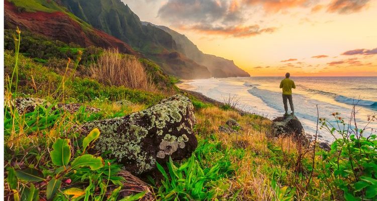 man standing on beach in Hawaii at sunset Hawaiian culture
