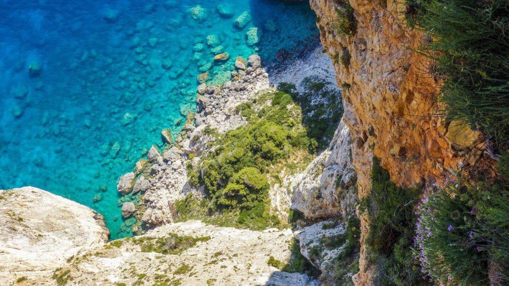 blue ocean cliffside Greece planning a trip to Europe