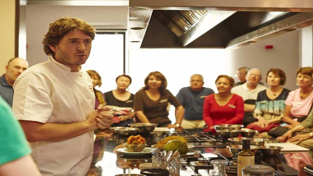 Chef Ignacio Barrios giving a cooking demonstration to Trafalgar guests in Lima, Peru