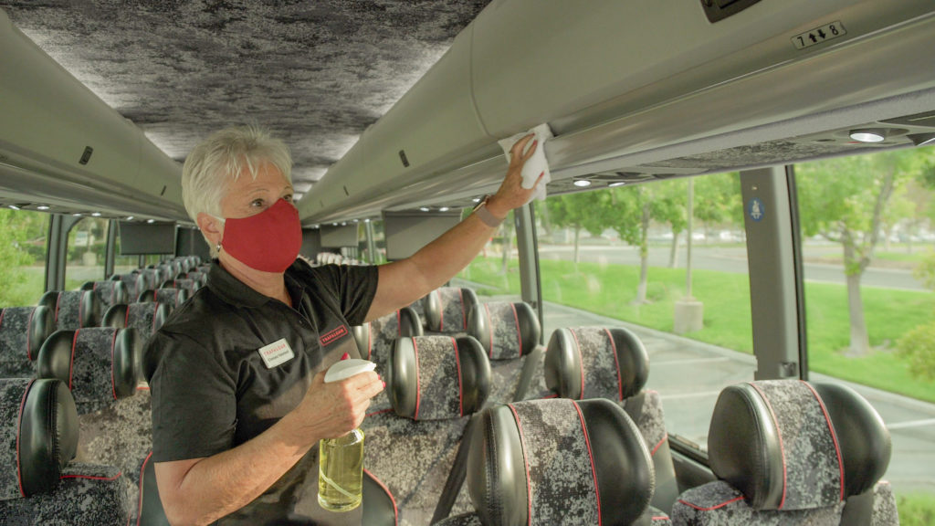 Trafalgar staff sanitising the coach