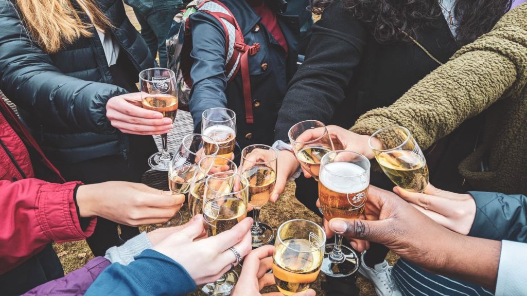 People clinking glasses together