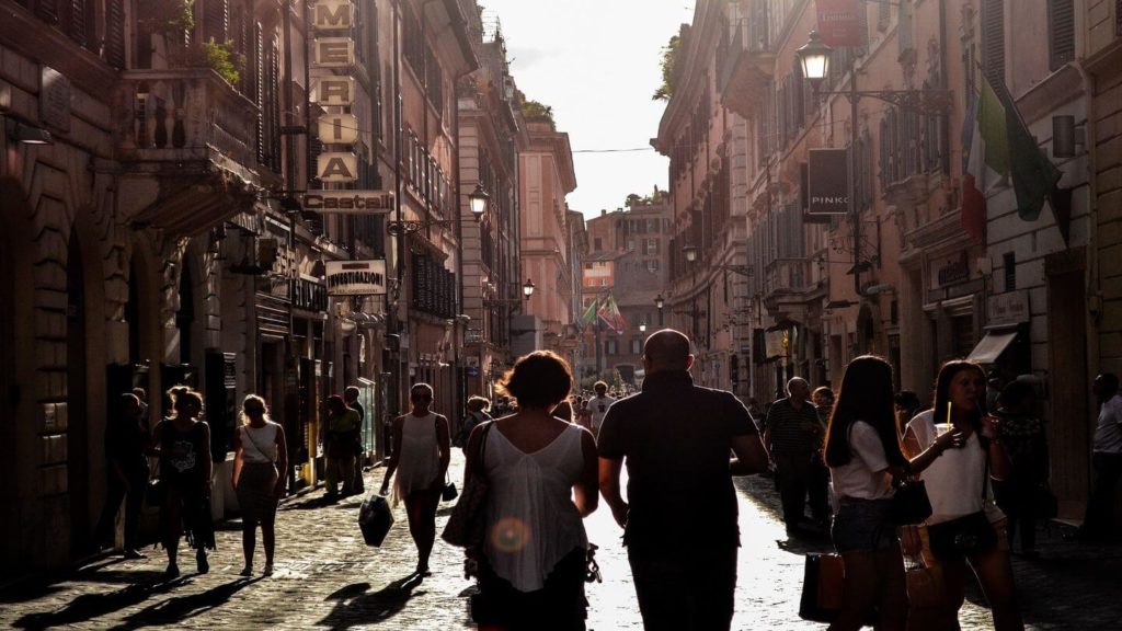 couple wandering through city street in Europe