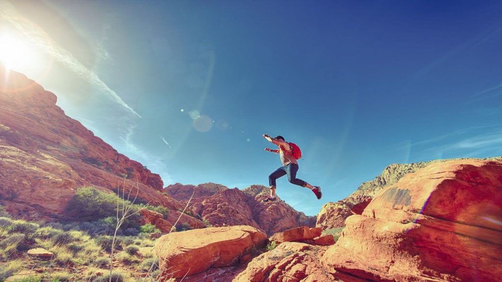 man jumping over rocks in a US national park