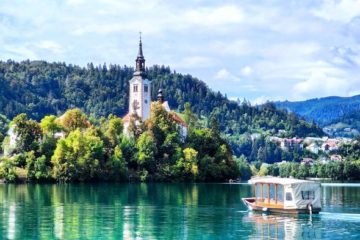 boat sailing across Lake Bled to Bled Island romantic travel experiences