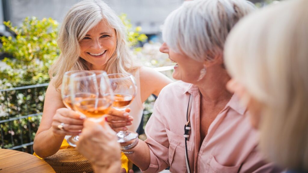 three women clinking glasses of wine