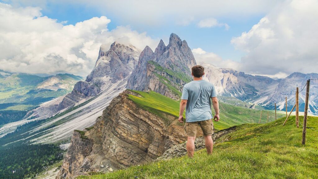 man standing on a mountain peak europe