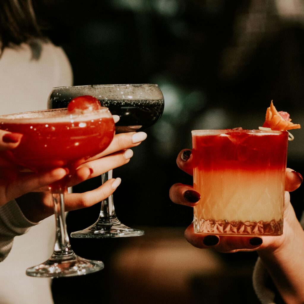 Three ritzy cocktails cheersing to a night out.