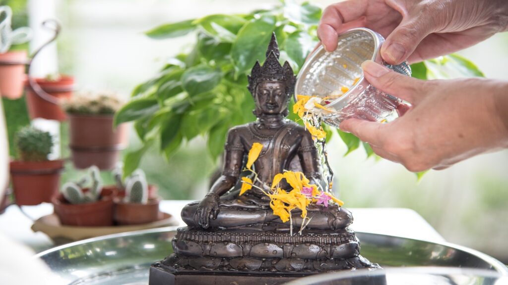 pouring water on Buddhist statue Songkran Thailand