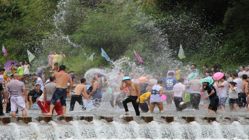 people having a water fight Songkran Thailand