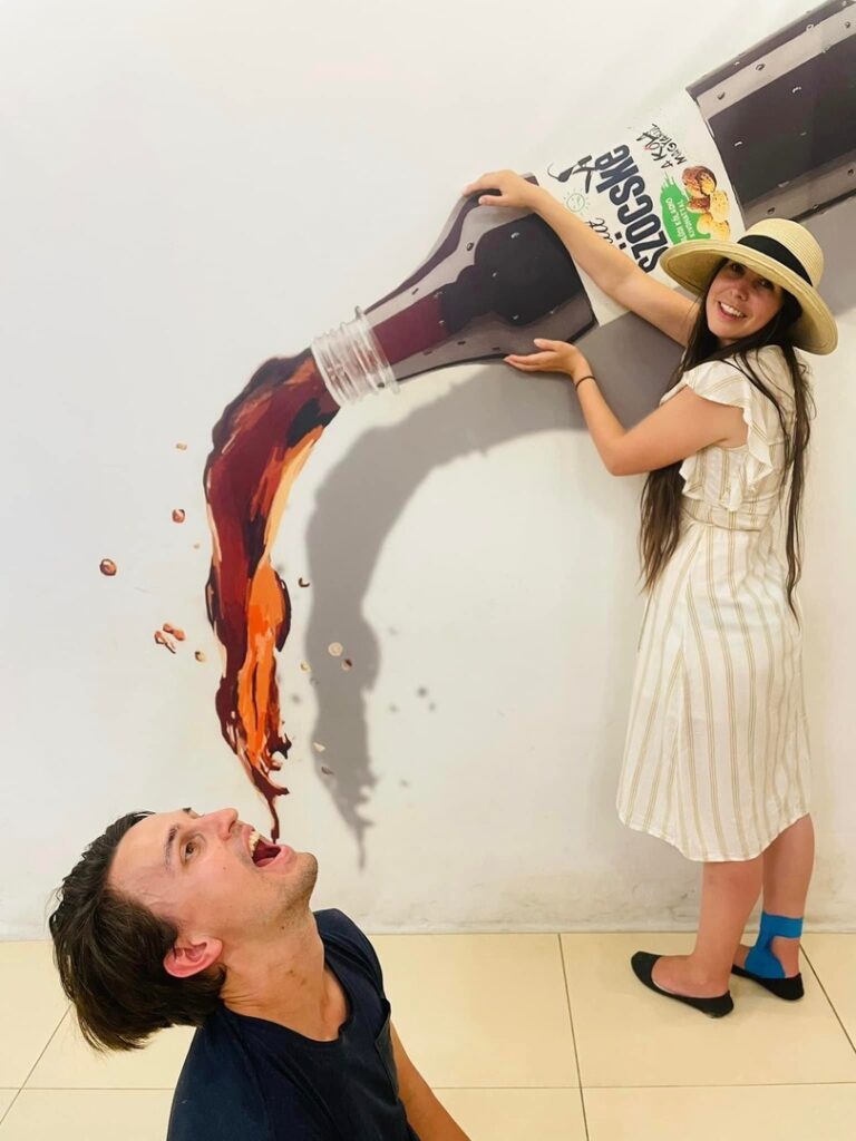 Madeline and husband posing for funny photos in a 3D museum in Budapest - Trafalgar Unlocked Award winners